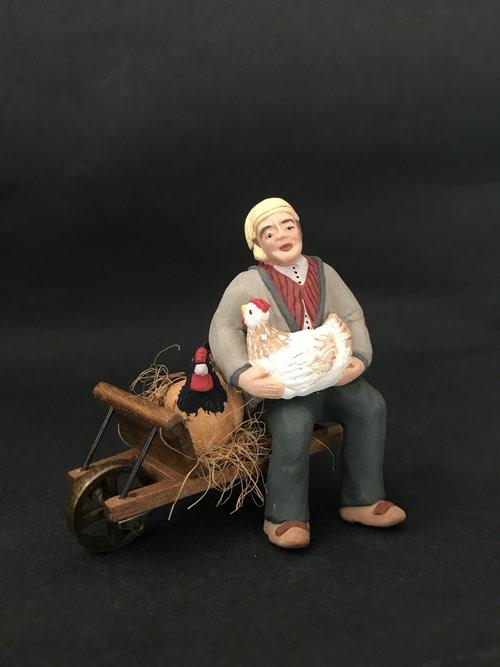 Homme aux poules  brouette   58 €