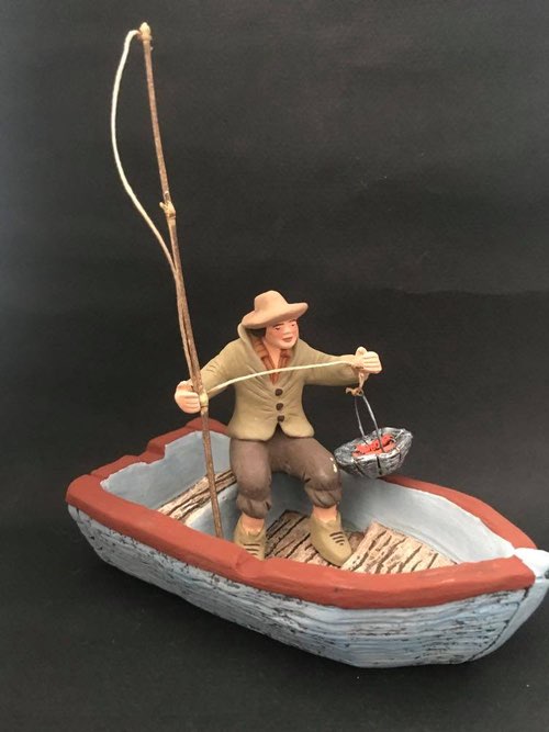 Pêcheur assis dans sa barque 